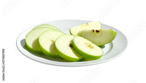 Sliced green apple arranged artfully on a white plate, showcasing freshness and culinary appeal against a dark background