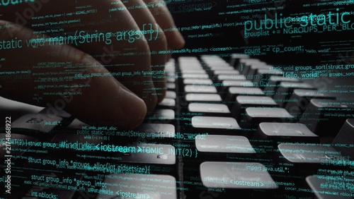 Fotografía A close-up image of hands actively typing on a computer keyboard, overlaid with programming code and digital data, showcasing the essence of technology and software development