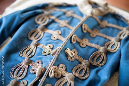 Canvas Print Ornate Blue Military Style Jacket Displayed Indoors