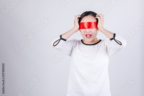 Картината върху платно Distressed blindfolded woman holding head in studio