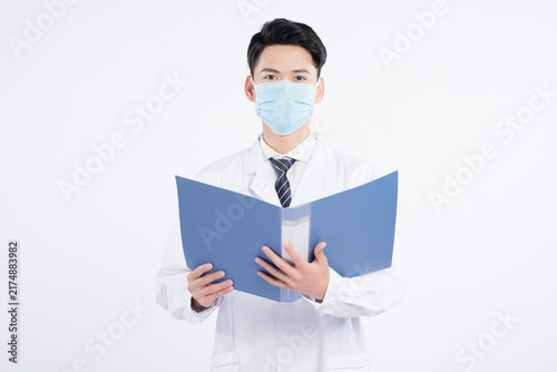 Photography Male doctor wearing face mask and holding blue folder on white background