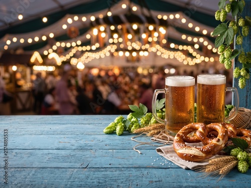 Oktoberfest beer and pretzel header with steins hops and wheat on wooden table for festival background and banner design