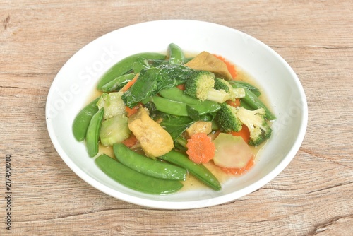 stir fried mixed vegetable with slice tofu in soy sauce vegetarian food on dish
