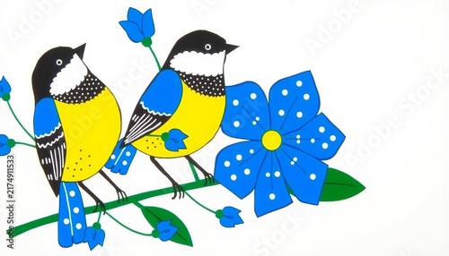 A beautiful blue tit with colorful yellow feathers and a blue wing sits on a budding spring branch among flowers