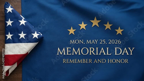 Memorial Day holiday text on blue cloth next to folded American flag