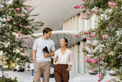 Couple enjoys a cheerful stroll surrounded by blooming flowers in a city