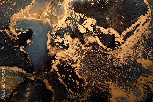 Artistic background featuring blue-gray swirls with gold accents; wide shot.