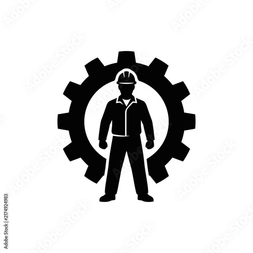 Worker silhouette standing inside large gear wheel representing industry and employment.