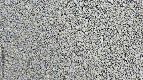 Canvastavla A close-up shot of a rough textured asphalt surface, showing tiny dark grey stones bound together
