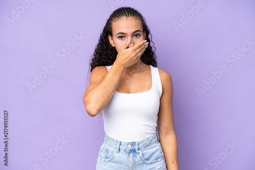 Fotografie Young woman isolated on purple background covering mouth with hand