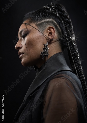 Empowerment Embodied: A striking portrait of a woman with bold hairstyle and intricate adornments, exuding strength and resilience.
