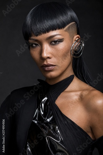 Avant-garde Style: A striking portrait of a woman with an edgy, futuristic hairstyle and bold makeup, exuding confidence and modern elegance.