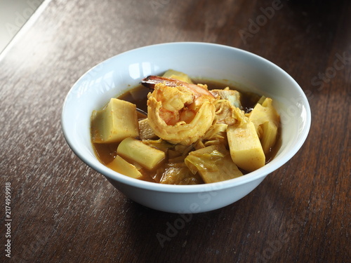 Gaeng Som, Thai spicy and sour curry, with tiger prawns and young coconut shoots