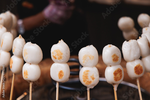 Dango on skewer, Mitarashi dango, traditional Japanese street food, grilled rice cake balls dumplings on wooden sticks, street food festival, Tokyo, Japan, market with local vendor stalls cooking