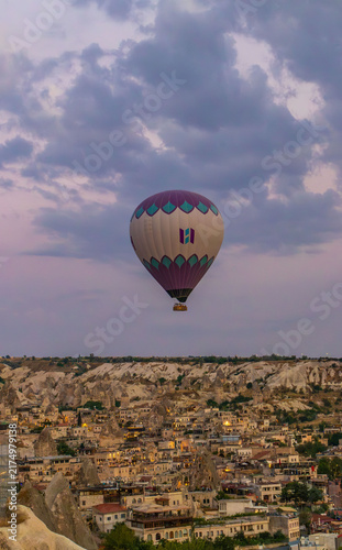 Hot air balloons flying over rocky valley at sunset. Hot air ballooning represents freedom exploration dream.