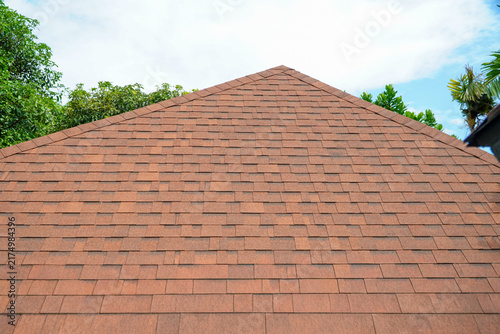 textured roof of the house with brown shingles,Orange-brown shingle roof