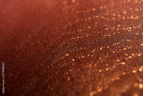 Artistic background featuring reddish-brown swirls with gold accents; photo of the surface.