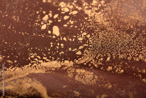Artistic background of reddish-brown swirls with gold accents – close-up photo