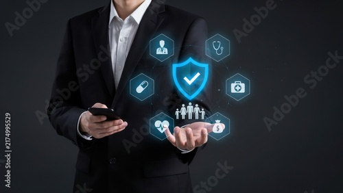 Businessman in a suit holding a smartphone with a floating holographic interface displaying medical insurance and healthcare protection service