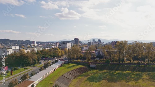Drone captures a wide view of Ljubljana Bezigrad, the capital city of Slovenia, displaying buildings and streets under a clear sky.
