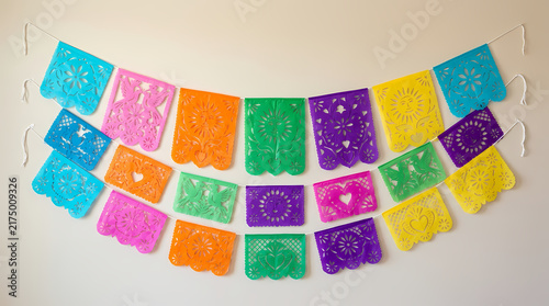 Colorful handcrafted paper bunting banners hanging to decorate for festive community celebrations and cultural gatherings during traditional folk events to bring joy and happiness to all local