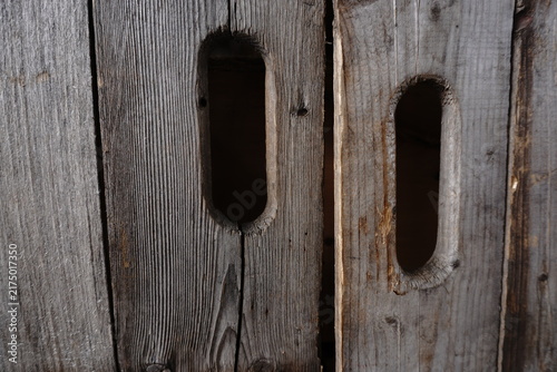 Quadro su tela Weathered wooden planks with carved oval handles showing grain and texture