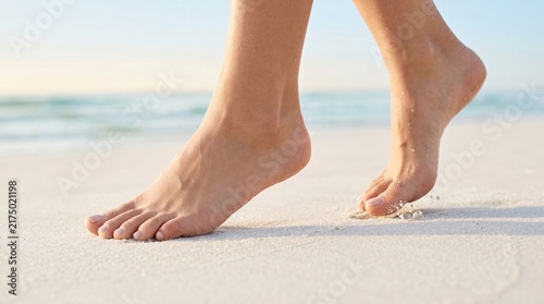 Perfect bare feet walking on pristine soft white sand with morning dew, clean minimalist composition, detailed skin, wellness ad style.