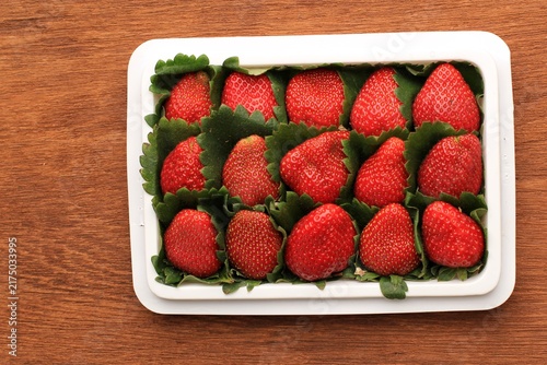 Konstfotografi Fresh RIpe Red Strawberry on White Plastic Packaging