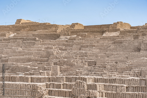 The complex, terraced adobe brick construction of the ancient Huaca Pucllana pyramid in the Miraflores district of Lima