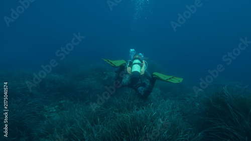 Bild auf Leinwand Scuba Divers Exploring Crystal Clear Mediterranean Sea off Mallorca Coast, Spain