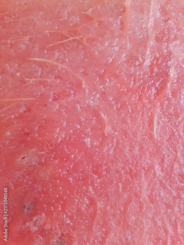Close-up of Fresh Watermelon Flesh. Pink flesh of the juicy watermelon. Tropical fruit background. Vertical photo.