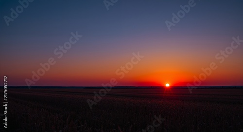 Sunrise and Moonset Over Field, A timelapse view of sunrise and moonset over a field set against a whimsical background offering ample space for text or graphics symbolizing the harmony of day