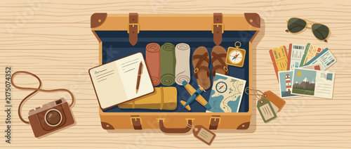 Open suitcase packed with travel essentials and accessories.