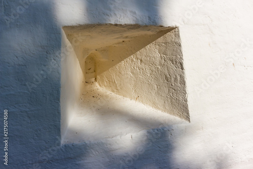Cuadro en lienzo Close-up of a weathered white defensive loophole in a historic monastery stone w
