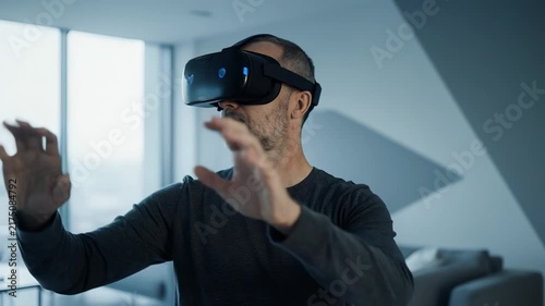 Man in VR headset interacting with digital space during daytime in modern apartment