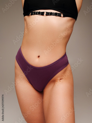 Foto Woman modeling purple high-waisted briefs and black bra