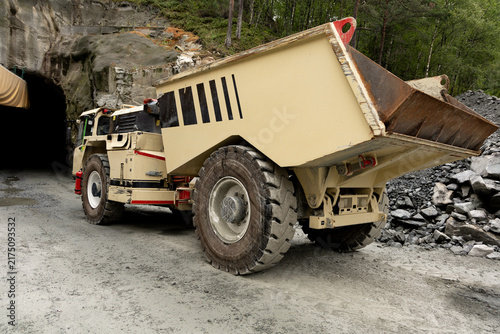 фотографія Heavy construction machinery with large dump bed positioned near tunnel entrance