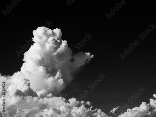Monochrome summer cumulonimbus cloud against a dark sky