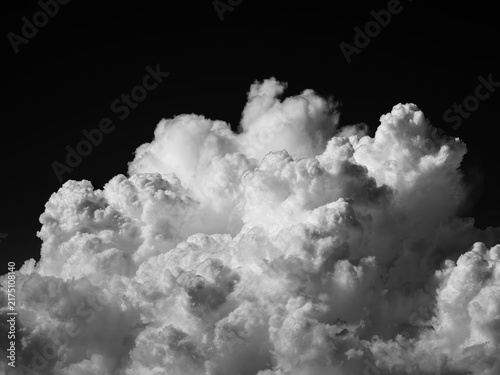 Monochrome summer cumulonimbus cloud against a dark sky