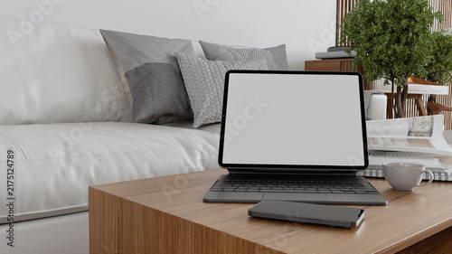 Blank tablet screen mockup on coffee table in cozy living room