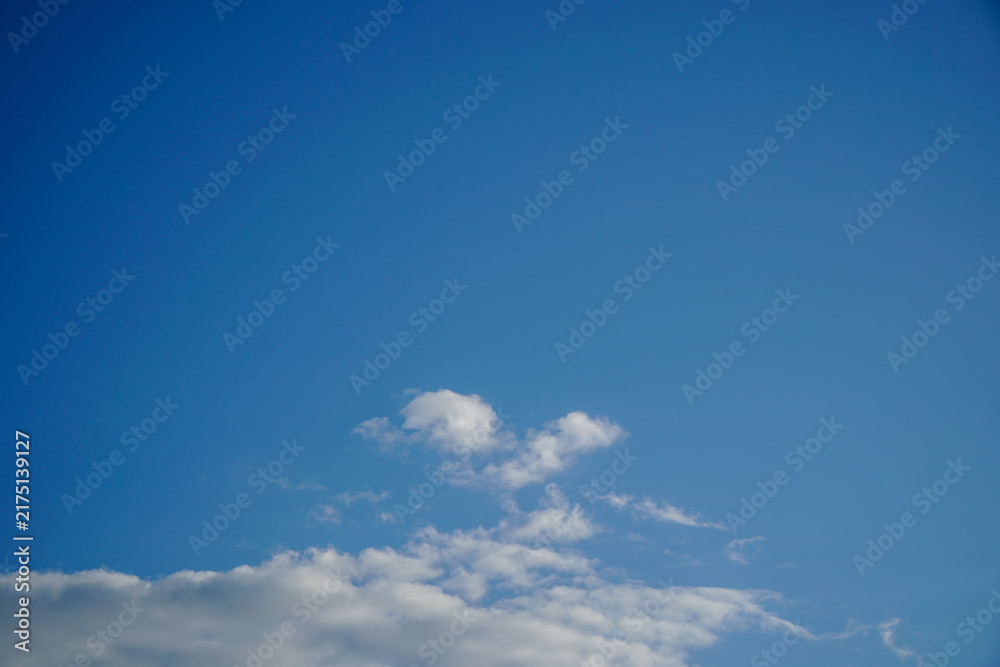 Fototapeta premium Minimal blue sky background with light white clouds horizontal