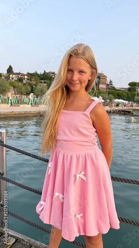 Fotografie Beautiful Blonde Girl in Pink Dress by the Adriatic Sea in Portoroz, Slovenia