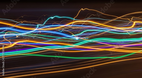 Vibrant neon light streaks across horizontal frame.