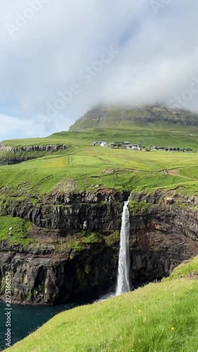 Múlafossur Waterfall at Faroe Islands in Summer. Vertical Footage
