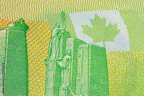 Canadian National Vimy Memorial detail on a 20 dollar polymer banknote, highlighting intricate fine-line engravings, maple leaf background pattern