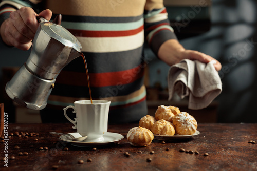 Photography Profiteroles with mascarpone and cup of black coffee.