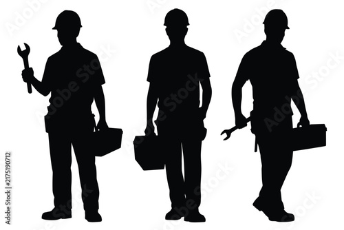 Three black silhouettes of construction workers or mechanics wearing hard hats, holding tools and toolboxes, standing in a row, isolated on a white background