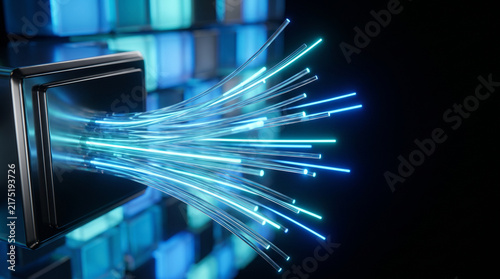 Fiber optic cables emitting light from a connector in a dark space  