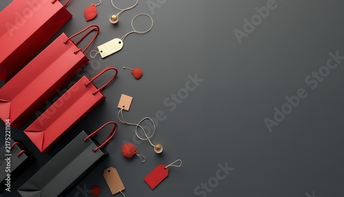 Red and black shopping bags with gold tags arranged on the left side of a dark gray surface