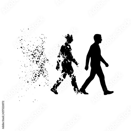 Canvas Print Silhouette of a man walking and slowly disintegrating into particles, concept of